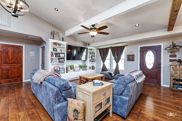 living room featuring dark wood-type flooring, ceiling fan with notable chandelier, and vaulted ceiling with beams