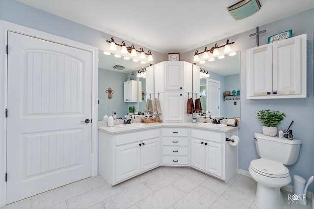 bathroom featuring vanity and toilet