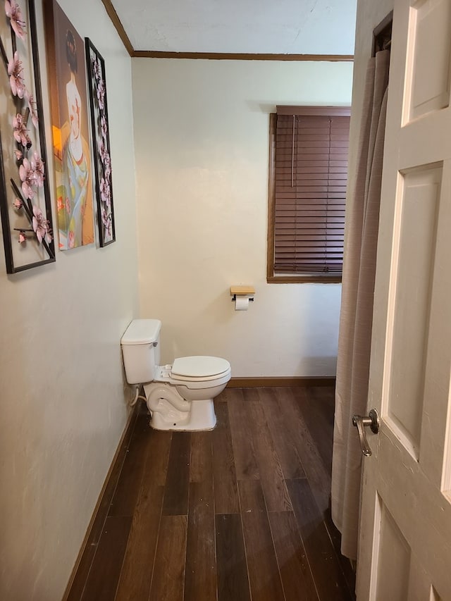 1811 Willow St, San Angelo, TX 76901 - bathroom with toilet, ornamental molding, wood finished floors, and baseboards