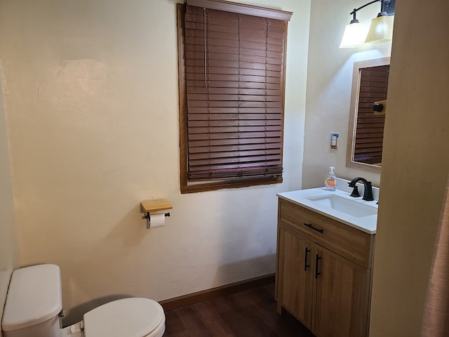 1811 Willow St, San Angelo, TX 76901 - bathroom with toilet, vanity, wood finished floors, and baseboards