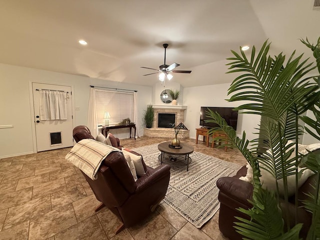 living room with a brick fireplace and ceiling fan