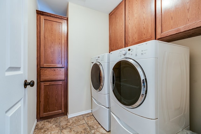 washroom featuring cabinets and independent washer and dryer