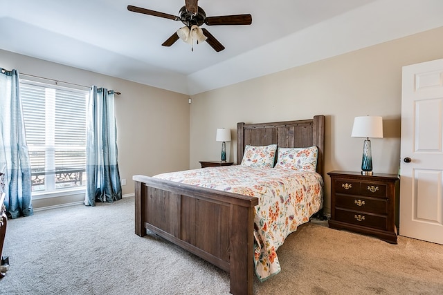 bedroom featuring lofted ceiling, light carpet, and ceiling fan