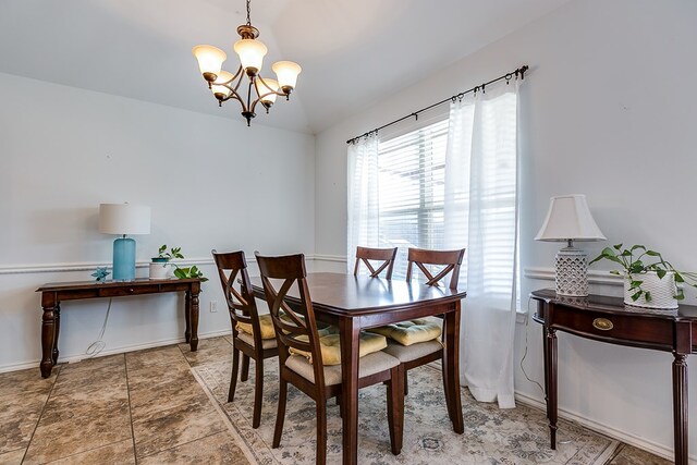 dining area with an inviting chandelier