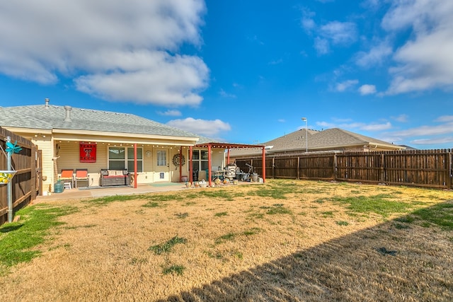 back of property featuring a yard and a patio area