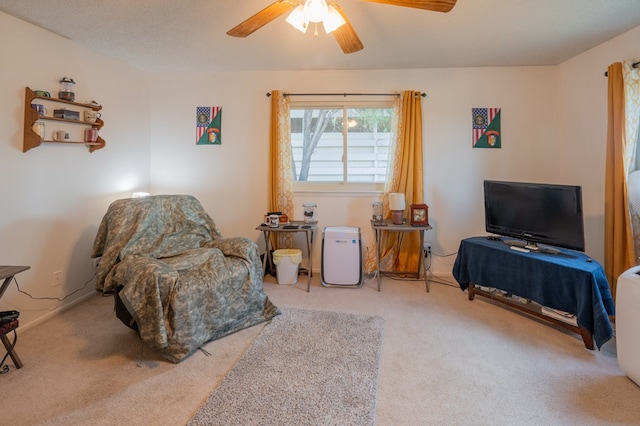 living area with carpet, a textured ceiling, and ceiling fan