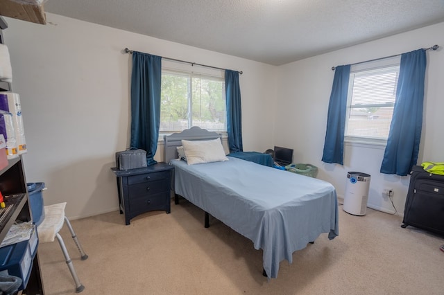 carpeted bedroom featuring a textured ceiling