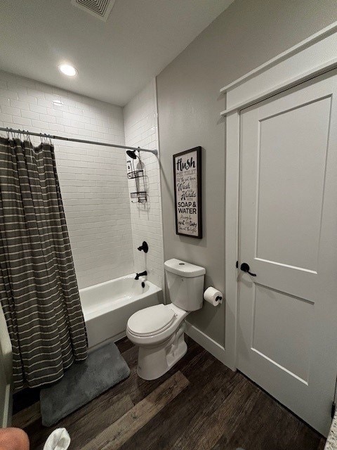 110 Vick Dr, Brownwood, TX 76801 - bathroom featuring hardwood / wood-style floors, shower / tub combo, and toilet