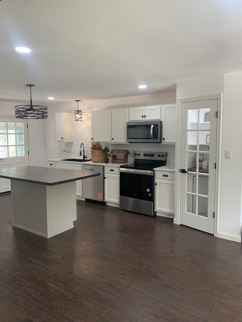 1619 Canal Rd, San Angelo, TX 76904 - kitchen featuring stainless steel appliances, white cabinets, decorative backsplash, recessed lighting, and a kitchen island