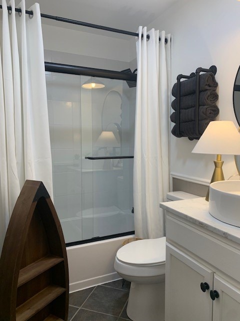 1619 Canal Rd, San Angelo, TX 76904 - bathroom featuring shower / bath combination with glass door, vanity, and tile patterned floors