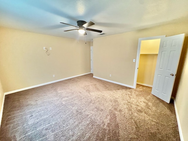 empty room featuring carpet floors and ceiling fan