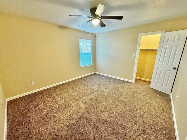 unfurnished bedroom with ceiling fan, carpet floors, and a closet