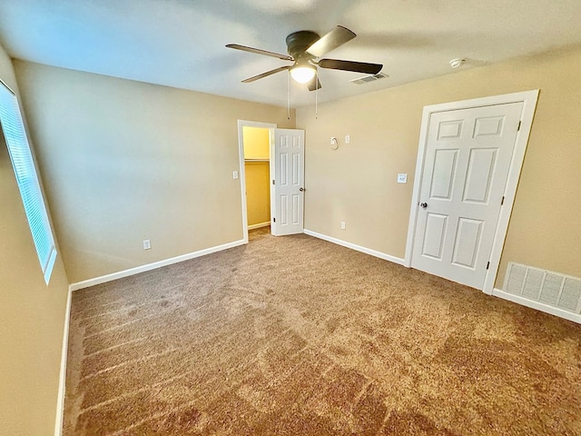 unfurnished bedroom featuring ceiling fan and carpet