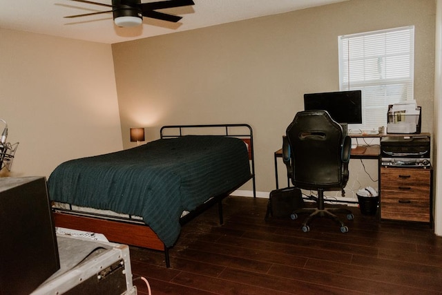 bedroom with dark hardwood / wood-style flooring and ceiling fan