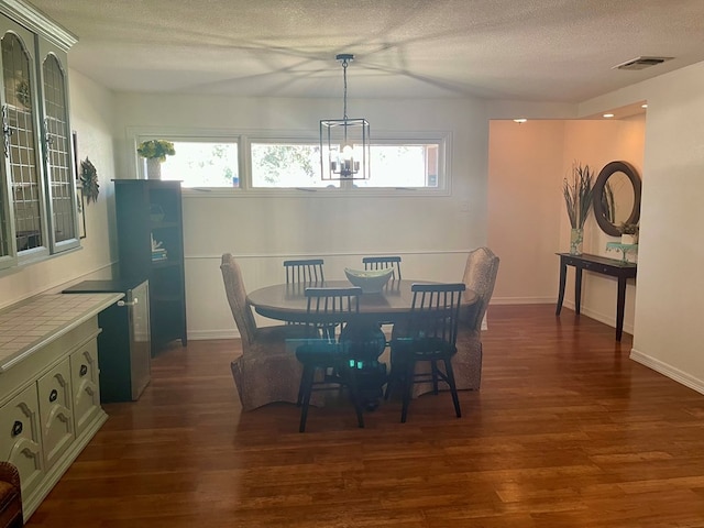 dining room featuring plenty of natural light, a chandelier, and dark hardwood / wood-style flooring