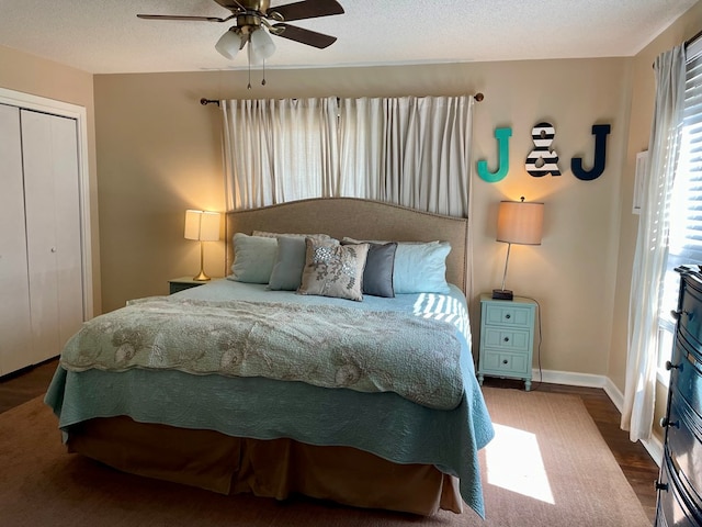 bedroom featuring ceiling fan, hardwood / wood-style floors, a closet, and a textured ceiling