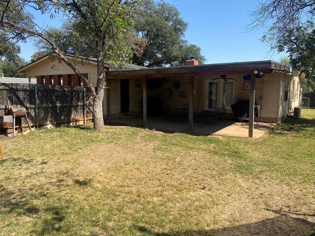 back of house featuring a yard, a patio area, and ceiling fan