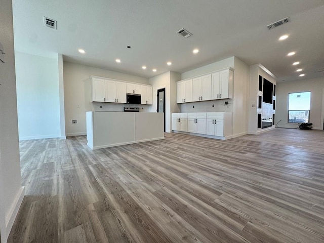 kitchen with white cabinetry and light hardwood / wood-style floors