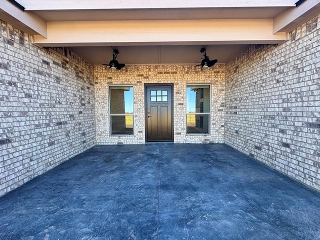 doorway to property featuring a patio and ceiling fan