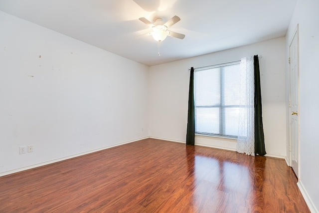 empty room featuring baseboards, ceiling fan, and wood finished floors