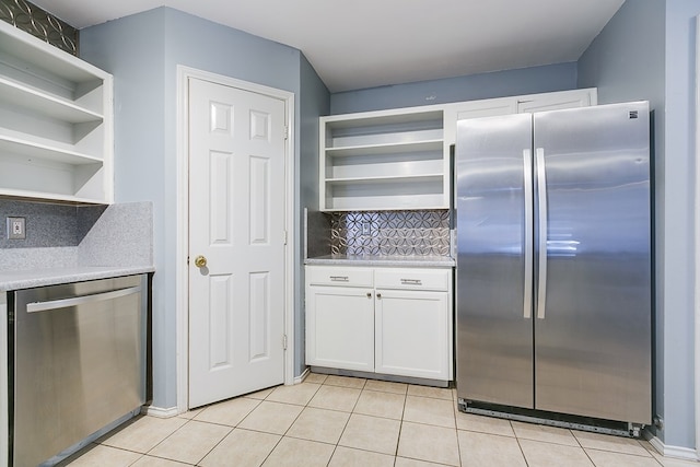 kitchen with white cabinetry, open shelves, light tile patterned flooring, and appliances with stainless steel finishes