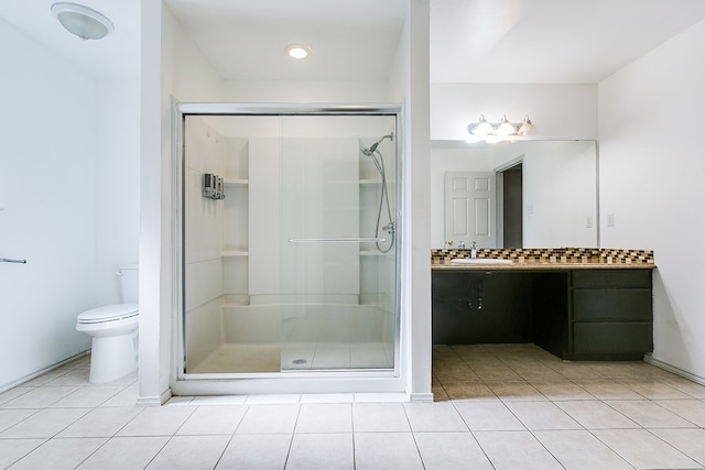 bathroom with toilet, a stall shower, vanity, and tile patterned flooring