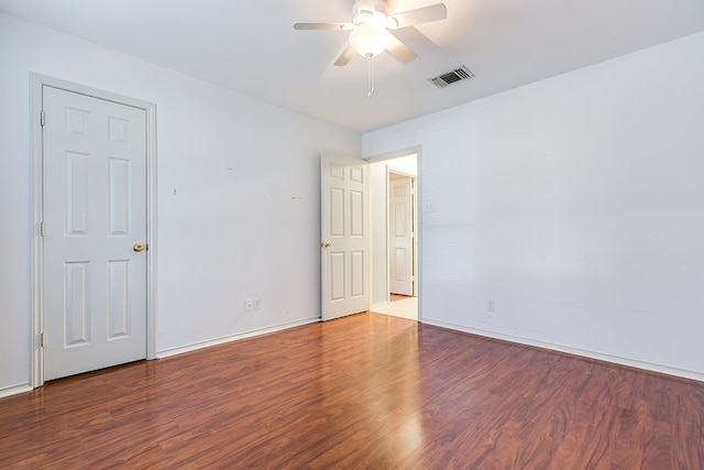 unfurnished room featuring visible vents, baseboards, a ceiling fan, and wood finished floors