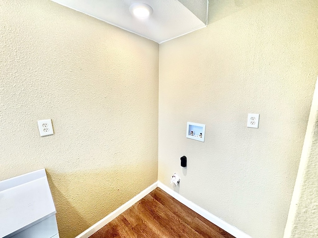 laundry area featuring washer hookup and hardwood / wood-style floors