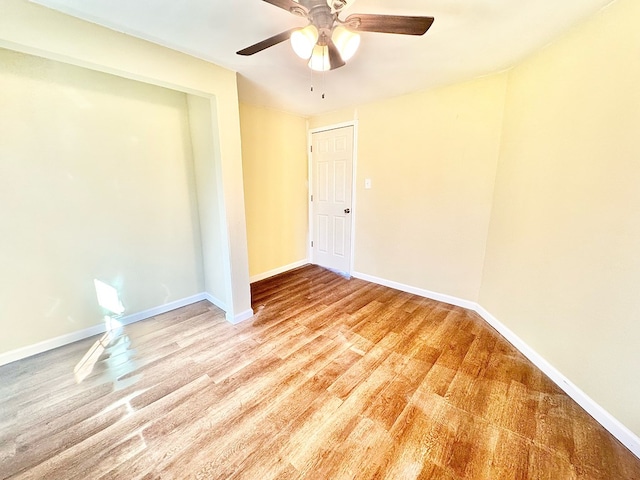 empty room with light hardwood / wood-style floors and ceiling fan