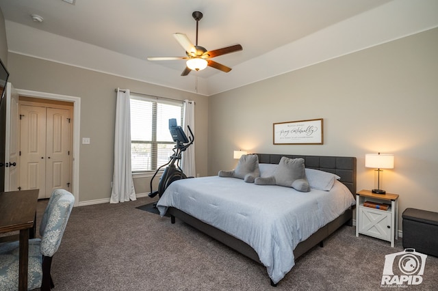 bedroom with ceiling fan, dark colored carpet, vaulted ceiling, and baseboards