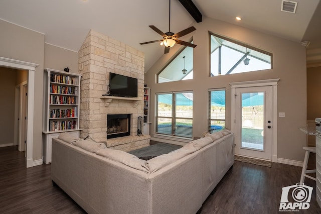 living area with visible vents, dark wood-style flooring, a fireplace, high vaulted ceiling, and beam ceiling