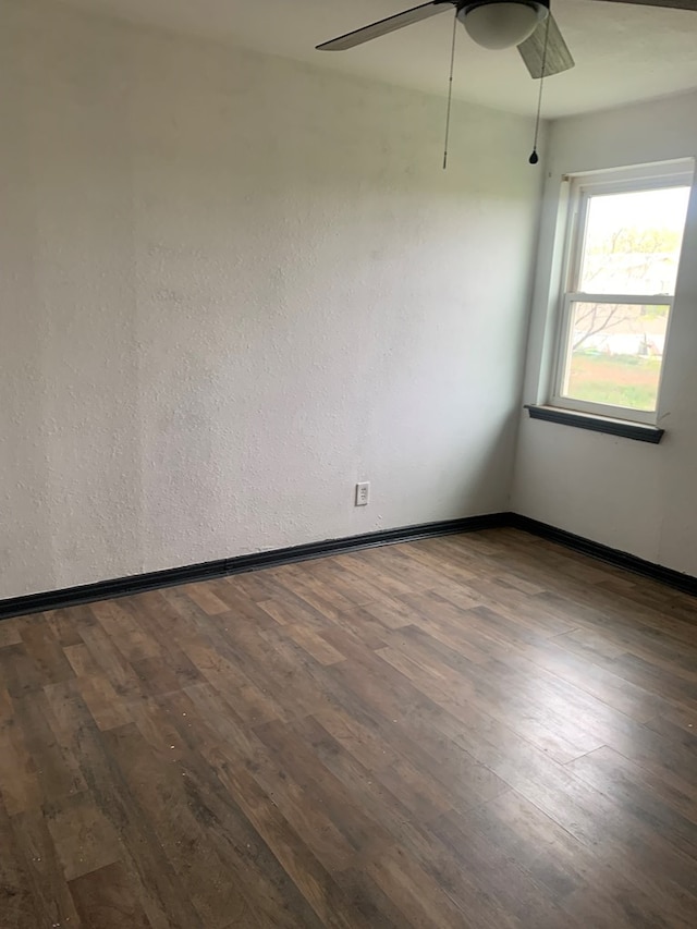 9991 Grape Creek Rd, San Angelo, TX 76901 - unfurnished room with ceiling fan, baseboards, and dark wood-type flooring