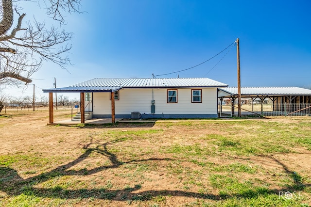 rear view of house with a yard