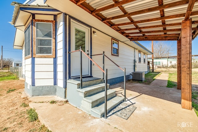 exterior space with central AC unit and a patio area