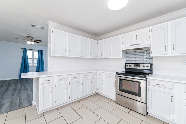 kitchen with light tile patterned floors, white cabinets, ceiling fan, and electric stove