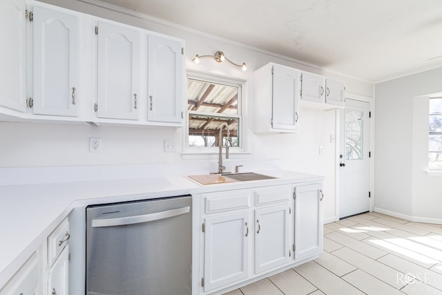 kitchen with white cabinetry, sink, ornamental molding, stainless steel dishwasher, and light hardwood / wood-style flooring