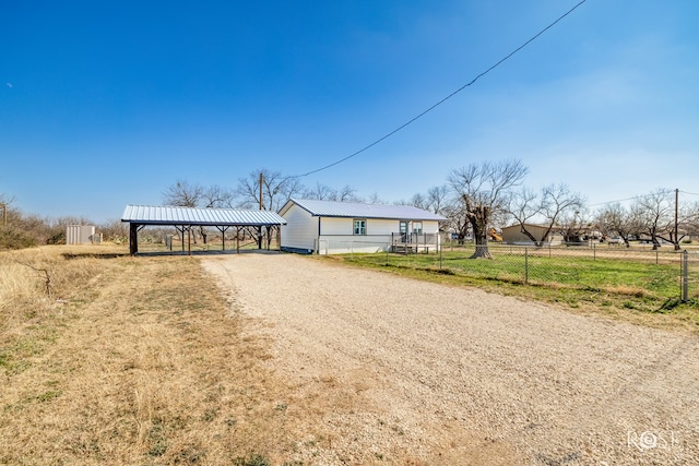 view of front of property with a carport and a rural view