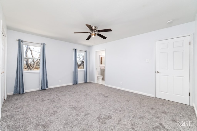 unfurnished bedroom with ceiling fan, carpet flooring, and ensuite bath