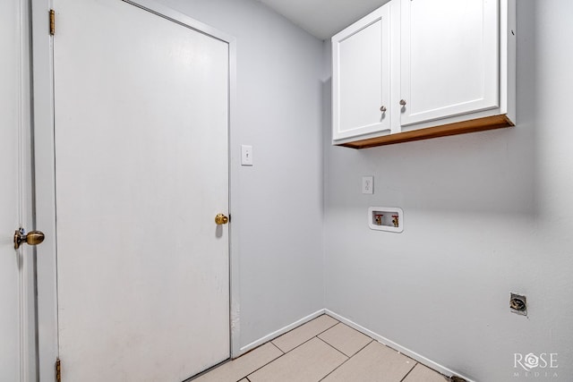 clothes washing area featuring cabinets, hookup for an electric dryer, and hookup for a washing machine