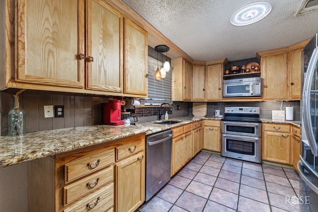 8126 N Fm 2288, San Angelo, TX 76901 - kitchen featuring stainless steel appliances, decorative backsplash, a textured ceiling, and light brown cabinets