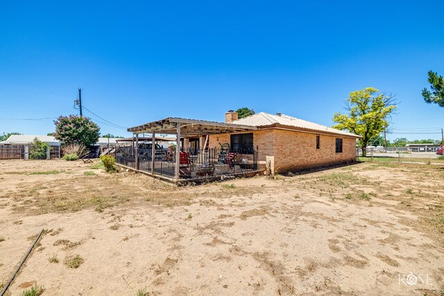 8126 N Fm 2288, San Angelo, TX 76901 - rear view of property featuring a chimney and brick siding