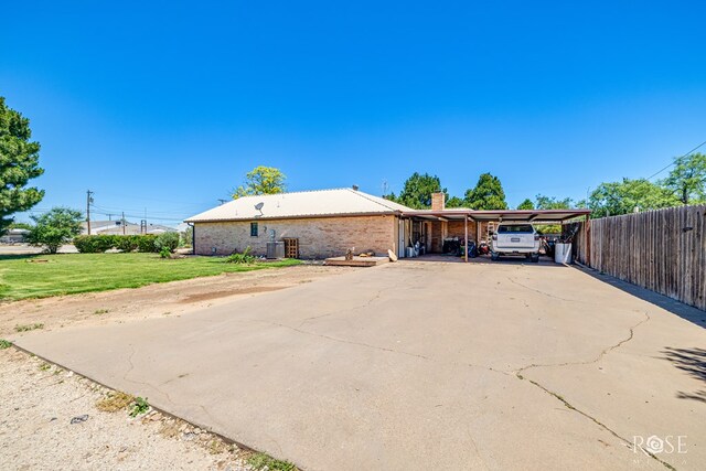 8126 N Fm 2288, San Angelo, TX 76901 - single story home featuring concrete driveway, a carport, a chimney, brick siding, and central AC