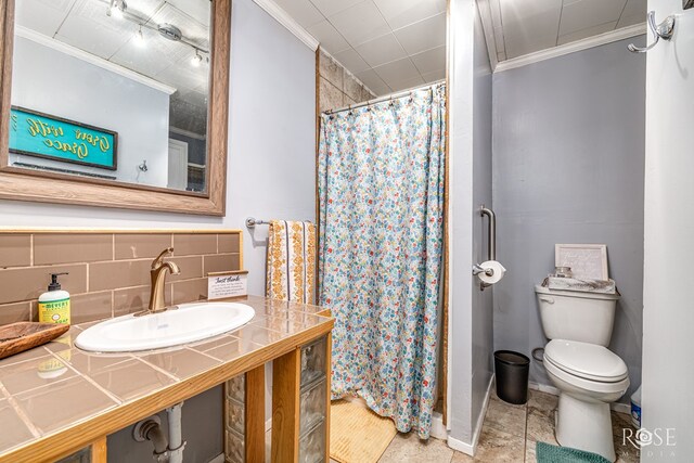 8126 N Fm 2288, San Angelo, TX 76901 - full bathroom featuring crown molding, toilet, a shower with shower curtain, vanity, and decorative backsplash