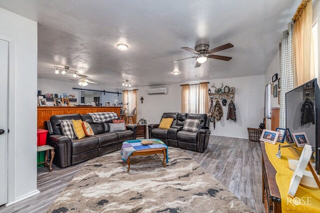 8126 N Fm 2288, San Angelo, TX 76901 - living room with a wall unit AC, ceiling fan, and wood finished floors