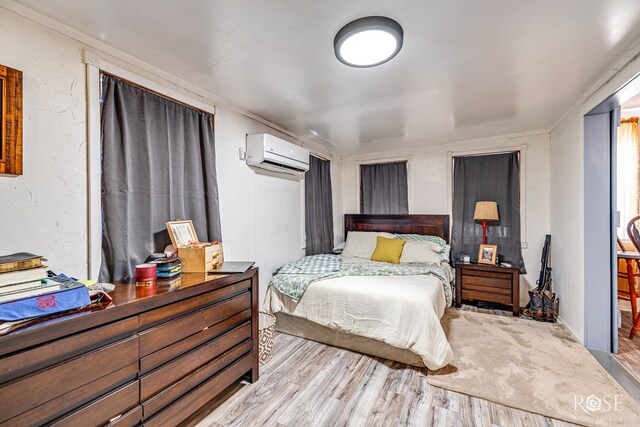 8126 N Fm 2288, San Angelo, TX 76901 - bedroom with a wall mounted air conditioner and wood finished floors