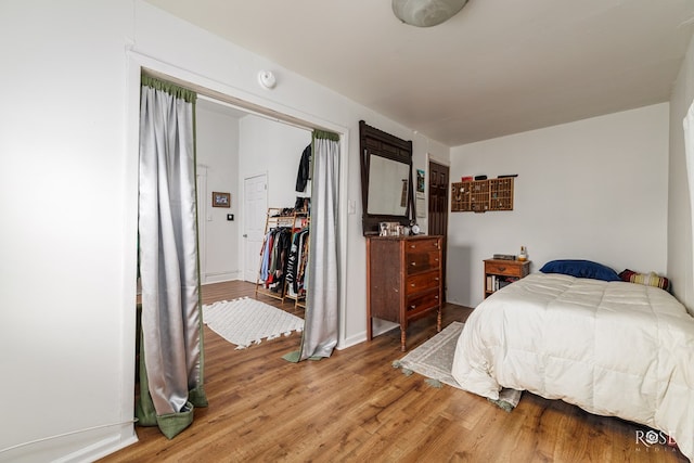 bedroom featuring hardwood / wood-style floors and a closet