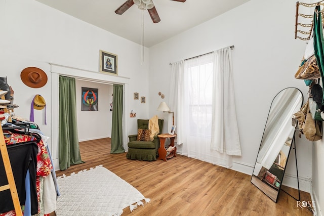 sitting room with ceiling fan and light wood-type flooring