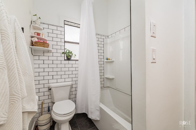 bathroom featuring tile patterned flooring, toilet, tile walls, and shower / bath combo with shower curtain