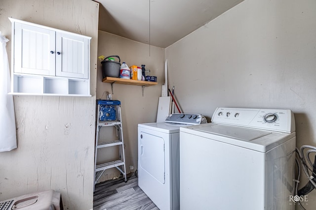 washroom featuring washing machine and dryer and light wood-type flooring