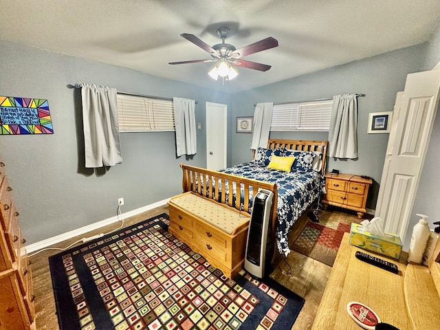 bedroom with ceiling fan and dark hardwood / wood-style flooring